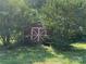 Outdoor red and white shed nestled among lush greenery at 1555 Moore Rd, York, SC 29745