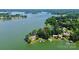 Stunning aerial shot of a waterfront estate featuring a private dock, boathouse, and expansive lawn at 160 Quail Hollow Dr, Kings Mountain, NC 28086
