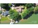 Captivating aerial view of a lakefront residence, showcasing a well-manicured lawn, private dock, and lush landscaping at 160 Quail Hollow Dr, Kings Mountain, NC 28086