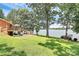 Expansive lawn leading to the lake with a wooden deck and stairs for easy access, perfect for outdoor enjoyment at 160 Quail Hollow Dr, Kings Mountain, NC 28086