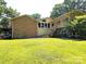 Expansive backyard featuring lush lawn and a two-story home with deck, perfect for outdoor living and entertaining at 160 Quail Hollow Dr, Kings Mountain, NC 28086