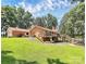 Spacious backyard featuring a detached garage, multilevel deck, and lush landscaping for outdoor enjoyment and entertaining at 160 Quail Hollow Dr, Kings Mountain, NC 28086