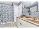 Bathroom featuring double sinks, white cabinetry, and a shower with a floral patterned curtain at 160 Quail Hollow Dr, Kings Mountain, NC 28086