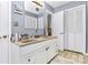 Bathroom featuring double sinks, white cabinetry, ample storage, and a neutral color palette at 160 Quail Hollow Dr, Kings Mountain, NC 28086