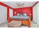 Bedroom with wood floors, ceiling fan, an area rug, and a metal framed bed with black and white covers at 160 Quail Hollow Dr, Kings Mountain, NC 28086