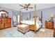 Bright bedroom featuring a four-poster bed, ample closet space, and warm hardwood floors at 160 Quail Hollow Dr, Kings Mountain, NC 28086