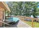 Enjoy the lake view from the spacious wooden deck featuring a hammock and railing for a relaxing outdoor experience at 160 Quail Hollow Dr, Kings Mountain, NC 28086