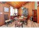 Cozy dining room offering warm wood-paneled walls, natural light, and a vintage charm at 160 Quail Hollow Dr, Kings Mountain, NC 28086