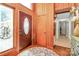 Foyer features wood paneled walls, a patterned rug and a decorative front door at 160 Quail Hollow Dr, Kings Mountain, NC 28086