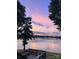 Picturesque lake view with a colorful sunset sky and a cozy seating area overlooking the water at 160 Quail Hollow Dr, Kings Mountain, NC 28086