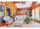 Cozy sunroom with tile flooring, wood paneling, vaulted ceiling, and access to a jacuzzi at 160 Quail Hollow Dr, Kings Mountain, NC 28086