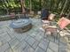 This backyard features a fire pit, stone pavers, and outdoor seating at 16115 Commodore Dr, Lancaster, SC 29720