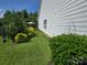 This home features a side yard with lush green grass, mature plantings, and privacy at 16115 Commodore Dr, Lancaster, SC 29720