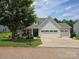 This charming home features a manicured lawn, two car garage, and a welcoming entry at 16115 Commodore Dr, Lancaster, SC 29720