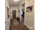 Warm hallway with hardwood floors, neutral walls, and decorative molding at 16115 Commodore Dr, Lancaster, SC 29720