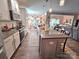 Open-concept kitchen with granite countertops, pendant lighting, and breakfast bar seating at 16115 Commodore Dr, Lancaster, SC 29720
