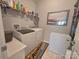 This is a laundry room with white washer, dryer, shelves, and additional storage at 16115 Commodore Dr, Lancaster, SC 29720