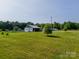 Charming country home featuring a well-manicured lawn and ample outdoor space for recreation and relaxation at 1640 Bear Poplar Rd, Cleveland, NC 27013