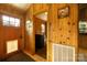 Inviting mudroom with wood paneling, pet door, and laundry area, conveniently located near the main entrance at 1640 Bear Poplar Rd, Cleveland, NC 27013