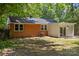 Exterior view showcasing a brick house with a cozy backyard and a modern extension, perfect for outdoor living and entertaining at 1709 Masonic Dr, Charlotte, NC 28205