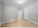Bedroom with gray walls, white trim, and wood-look flooring showcases doorways at 1709 Masonic Dr, Charlotte, NC 28205