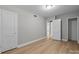 Bedroom with gray walls, white trim, and wood-look flooring showcases natural light at 1709 Masonic Dr, Charlotte, NC 28205