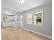 The dining room features light gray walls, white trim, wood-look flooring, and an open floor plan at 1709 Masonic Dr, Charlotte, NC 28205