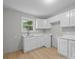 Bright kitchen features white cabinets, light countertops, a stainless sink, and a window view at 1709 Masonic Dr, Charlotte, NC 28205