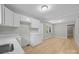 Modern kitchen featuring white cabinets, sleek countertops, and a pass-through to the living area, all freshly updated at 1709 Masonic Dr, Charlotte, NC 28205