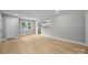 Open-concept living area with new flooring, fresh paint, and a view into the bright kitchen space at 1709 Masonic Dr, Charlotte, NC 28205