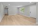Spacious living room featuring sleek flooring, a large window, and a freshly painted neutral palette at 1709 Masonic Dr, Charlotte, NC 28205