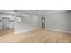 Bright living room with wood-look flooring, fresh paint, and a view into the adjacent kitchen at 1709 Masonic Dr, Charlotte, NC 28205