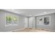 Bright and airy living room with multiple windows and fresh paint, showcasing the new wood-look floors at 1709 Masonic Dr, Charlotte, NC 28205
