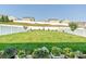 Expansive backyard featuring a well-manicured lawn, white fence, and colorful flower planters at 177 Yellow Birch Loop, Mooresville, NC 28117