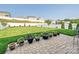 Beautifully landscaped backyard with a stone patio, lush green lawn, and privacy fencing at 177 Yellow Birch Loop, Mooresville, NC 28117