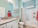 Stylish bathroom featuring a granite vanity top, white cabinets, framed art, and a shower-tub combination at 177 Yellow Birch Loop, Mooresville, NC 28117