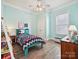 Colorful bedroom with a ceiling fan, wood floors, and a charming bed with decorative pillows at 177 Yellow Birch Loop, Mooresville, NC 28117