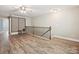 Spacious bonus room with hardwood flooring, a decorative railing, and ample natural light from windows at 177 Yellow Birch Loop, Mooresville, NC 28117