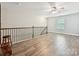 Bright bonus room with wood floors, a ceiling fan, a small stool, and lots of natural light at 177 Yellow Birch Loop, Mooresville, NC 28117