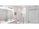 Bright bathroom featuring double vanity, white cabinetry, and glass enclosed shower at 2009 Trindle Vine Ln, Waxhaw, NC 28173