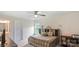 Bedroom with a modern bed frame, ceiling fan, neutral paint, and bright light from the window at 2009 Trindle Vine Ln, Waxhaw, NC 28173