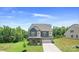 Charming two-story home featuring a stone facade, blue accents, and a well-manicured front yard at 2009 Trindle Vine Ln, Waxhaw, NC 28173