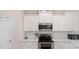 Bright kitchen features white cabinets, stainless steel microwave, and modern countertops at 2009 Trindle Vine Ln, Waxhaw, NC 28173