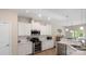 Modern kitchen with white cabinets, stainless steel appliances, and quartz countertops at 2009 Trindle Vine Ln, Waxhaw, NC 28173