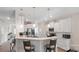 Open kitchen featuring white cabinets, a breakfast bar with seating, and stainless appliances at 2009 Trindle Vine Ln, Waxhaw, NC 28173
