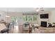 Comfortable living room with a fireplace, large windows, and hardwood floors at 2009 Trindle Vine Ln, Waxhaw, NC 28173
