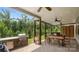Outdoor dining area with a built-in grill, ceiling fans and natural views, perfect for entertaining at 2009 Trindle Vine Ln, Waxhaw, NC 28173