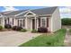 Inviting brick townhome with a concrete driveway and lush lawn, enhanced by stylish shutters at 2045 Pin Oak Pl, Cramerton, NC 28032