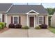Charming brick townhome with a well-manicured front yard and a cozy covered entry at 2045 Pin Oak Pl, Cramerton, NC 28032