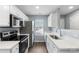 Modern kitchen featuring stainless steel appliances, white cabinets, and sleek countertops at 2045 Pin Oak Pl, Cramerton, NC 28032